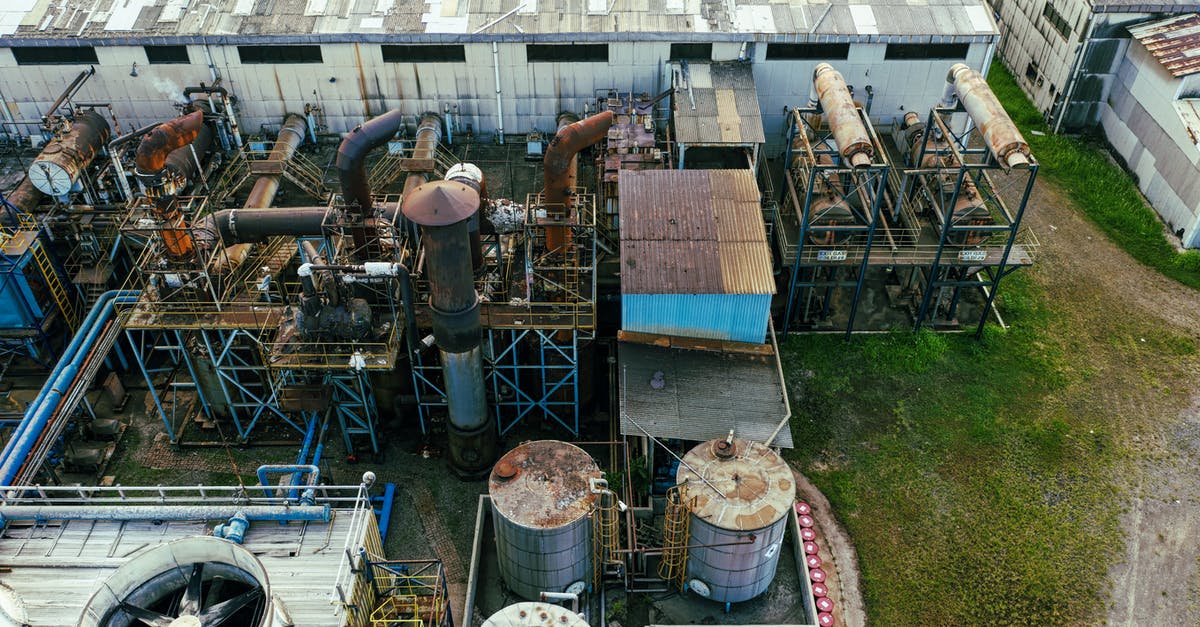 How to saute without oil on stainless steel pots/pans? - Drone view of industrial area with barrels for petroleum products and pipes connected with warehouses