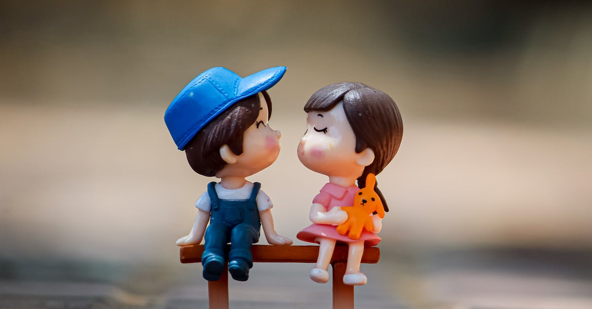 How to season / care for a Bundt pan? - Tiny figurine of cute little girl and boy sitting on bench together and kissing