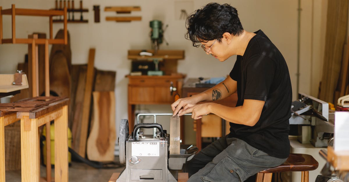 How to sharpen knife with chunk missing? - Professional ethnic artisan sitting at sharpening tool