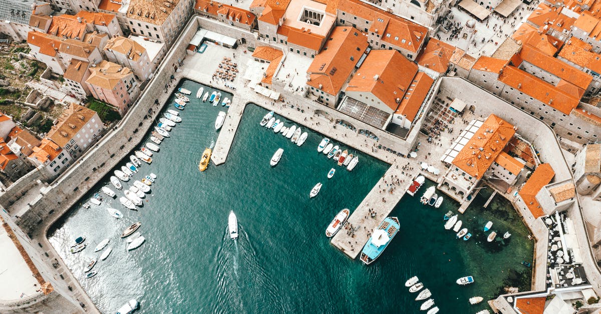 How to ship holiday cookies? - Breathtaking drone view of coastal town with traditional red roofed buildings and harbor with moored boats in Croatia