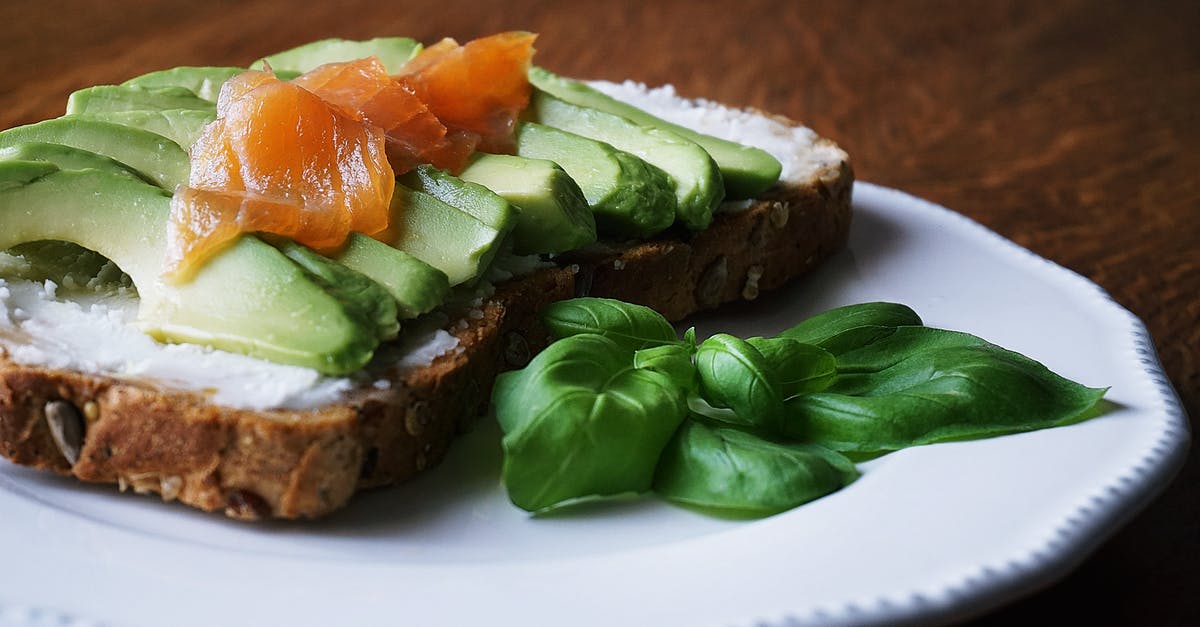 How to slice smoked salmon really thinly? - Bread With Sliced Avocado and Salmon Near Basil Mint on Plate