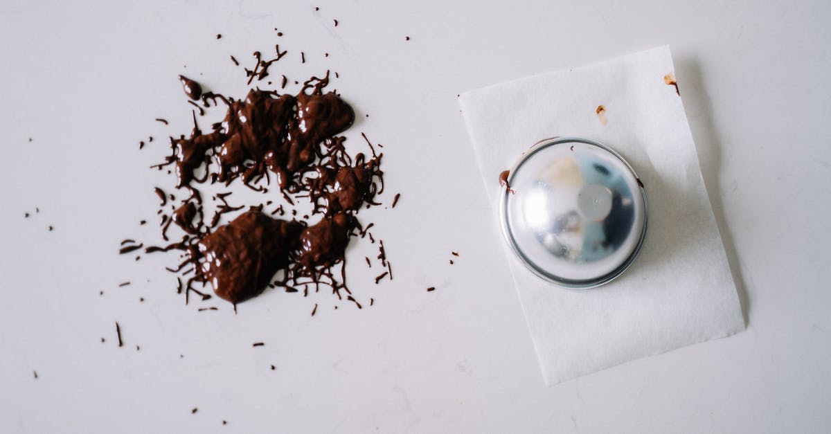 How to solidify melted chocolate? - Melted Chocolate on a White Surface Near a Metal Container