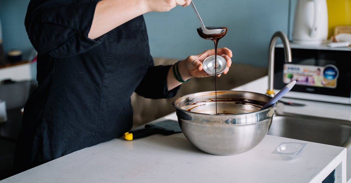 How to solidify melted chocolate? - A Person Scooping Melted Chocolate From a Stainless Bowl