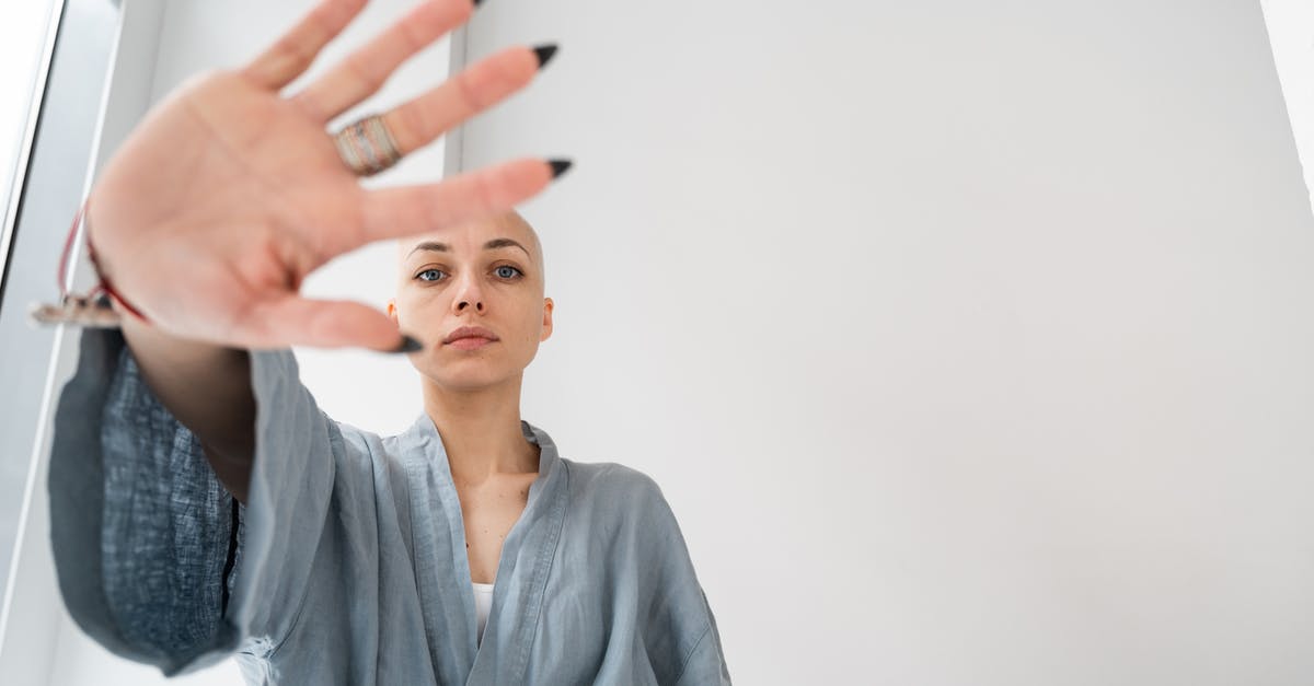 How to stop cupcakes from collapsing? - Patient showing stop gesture in light clinic