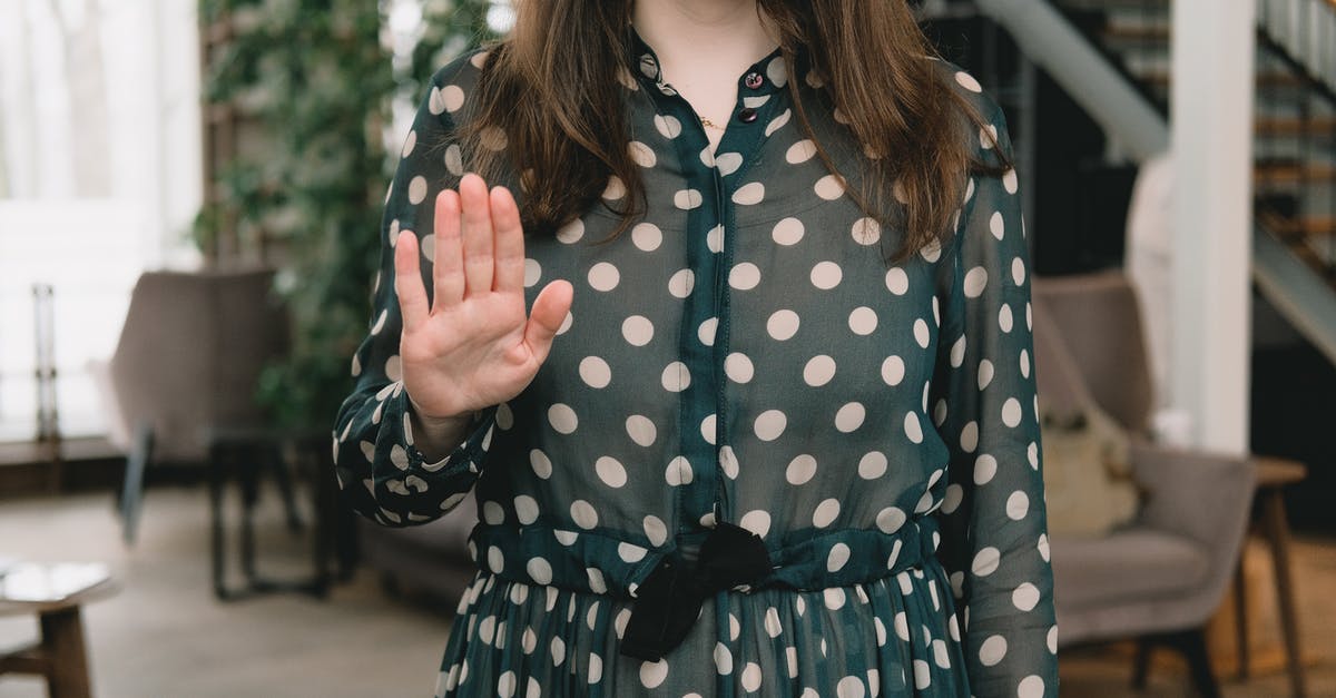 How to stop meatballs falling apart when frying - Crop feminine woman showing stop gesture in modern apartment