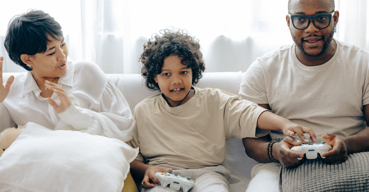 How to stop meatballs falling apart when frying - Interested ethnic kid preventing father from winning in video game while resting together with mother in living room