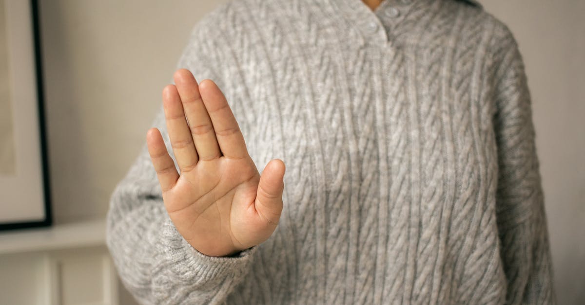 How to stop meatballs falling apart when frying - Crop woman in gray knitted jumper doing stop gesture