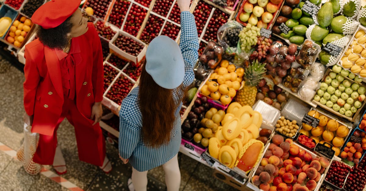 How to store fresh figs - Woman in Blue Denim Jacket and White Pants Carrying a Basket of Fruits