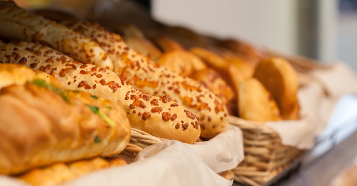 How to store homemade granola? - Tasty assorted fresh baked baguettes and buns with bread placed in wicker baskets on shelf in light store