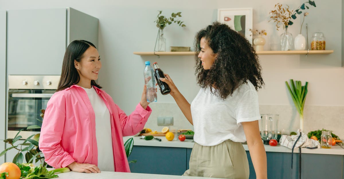 How to store Soda Water or other Home Made Sodas? - Two Women Looking at Each Other while Holding Drinks