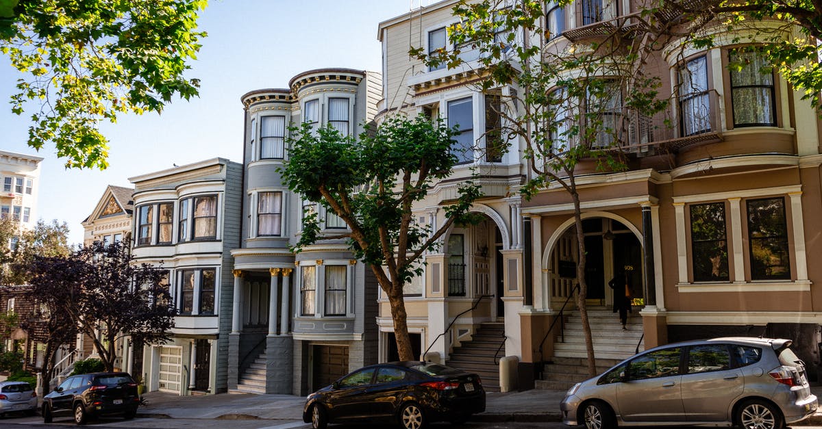 How to taste a real ranch dressing outisde of the US - Cars parked near mansions in city residential district in sunlight