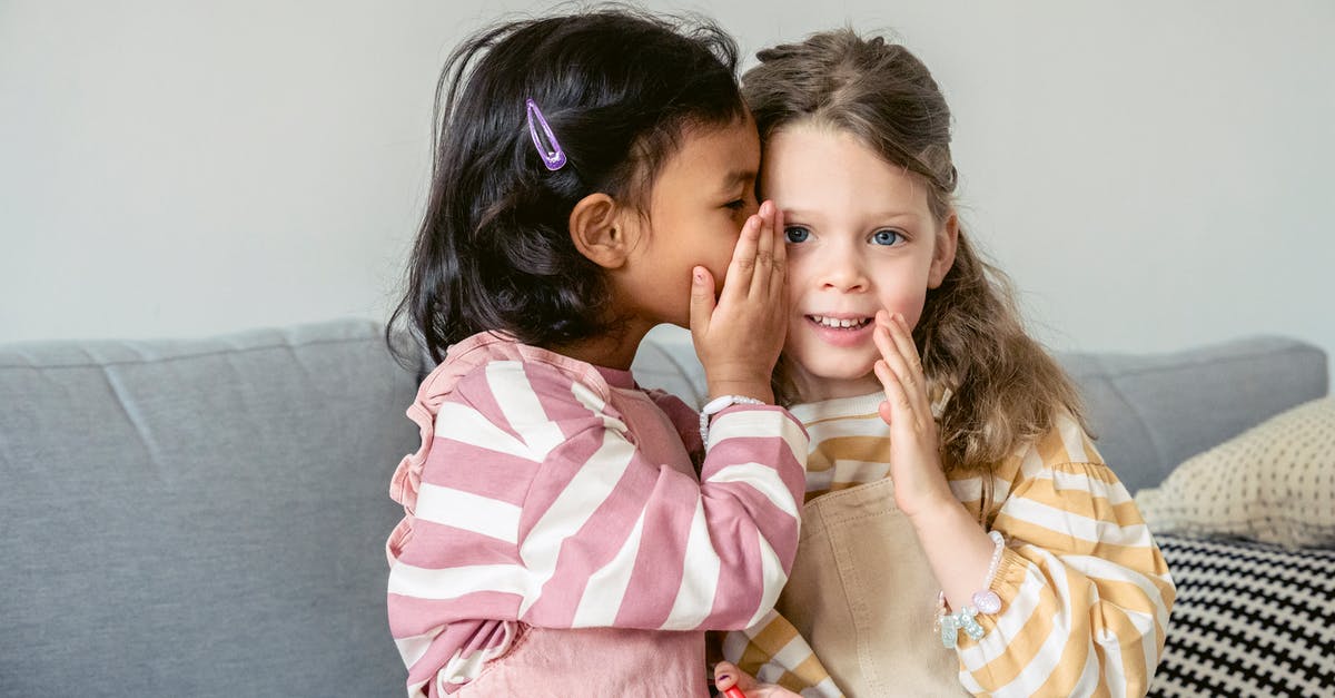 How to tell when broccoli has gone bad? - Ethnic girl sitting on sofa close to smiling best friend and whispering secrets on ear