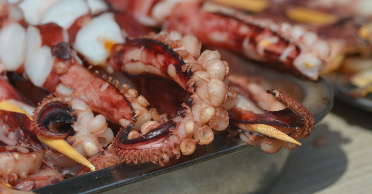 How to tenderize squid for ika nigiri? - Close-Up Photograph of Skewered Tentacles