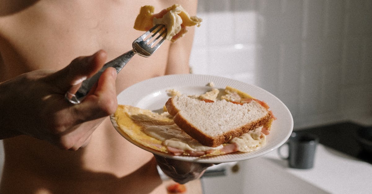 How to thicken bleu cheese dressing? - Person Holding Stainless Steel Fork and Knife Slicing Cake