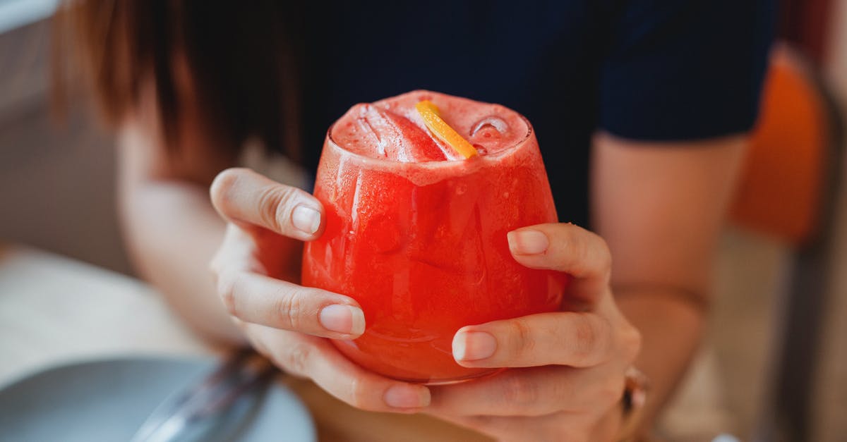 How to turn froth into juice? - Crop woman with cocktail in hands