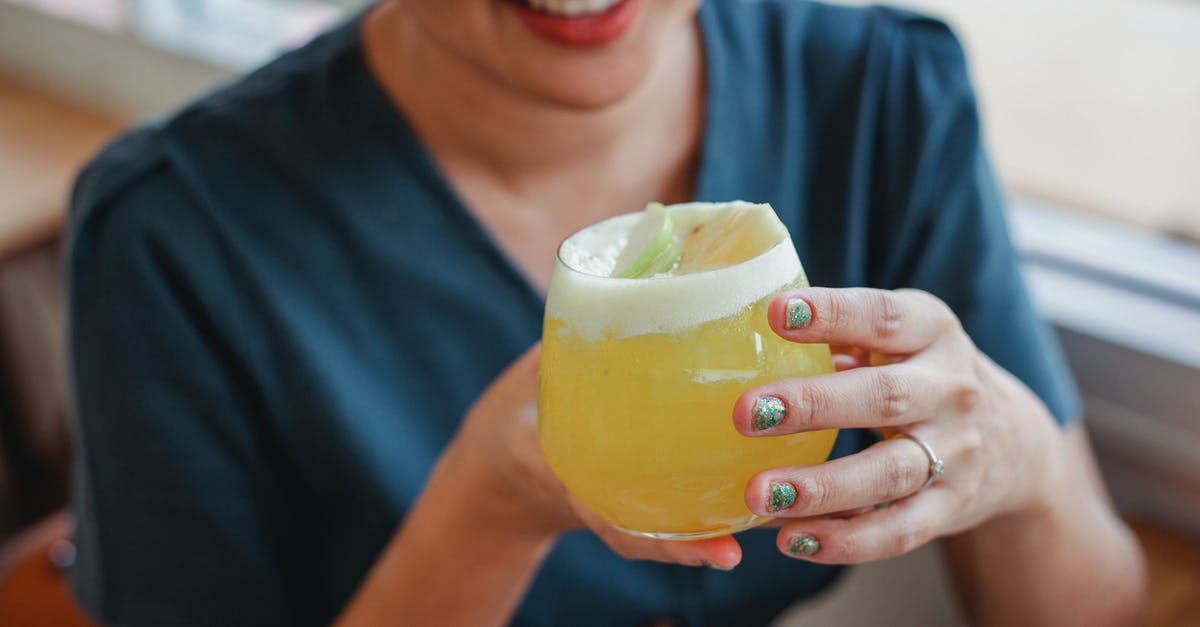 How to turn froth into juice? - Crop woman with glass of cocktail