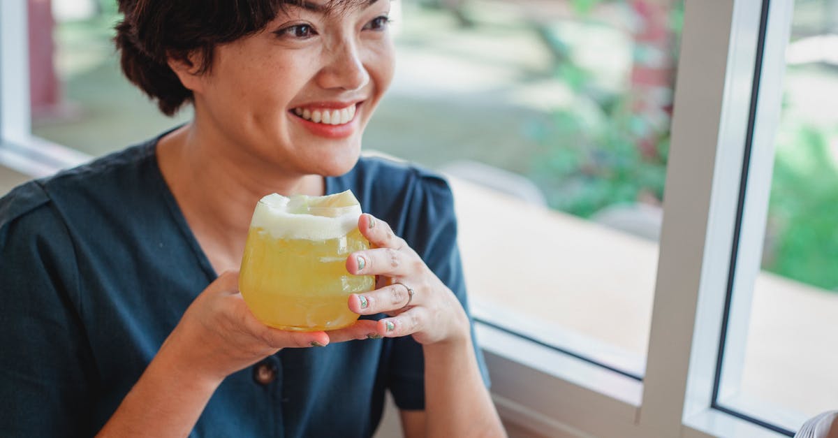 How to turn froth into juice? - Happy Asian woman with cocktail