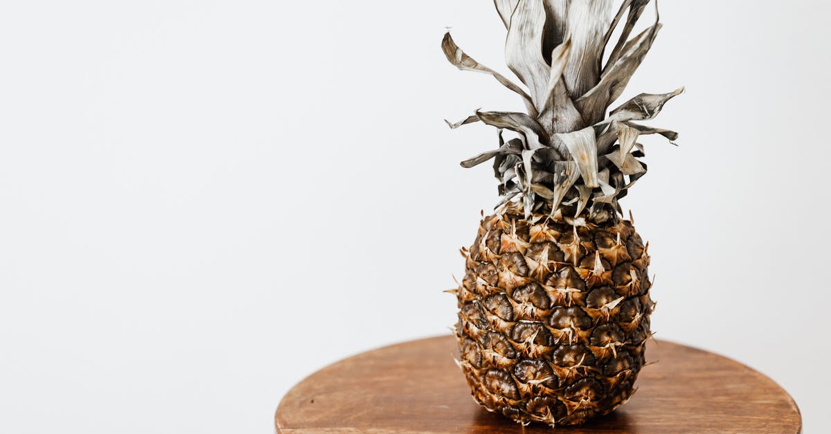 how to unstick dried pineapple chunks that are stuck together - Decorative whole pineapple placed on wooden surface