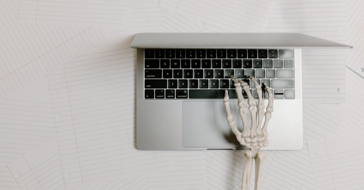 How to use Bones in Soups? - Overhead Shot of a Skeleton Hand Typing on a Laptop