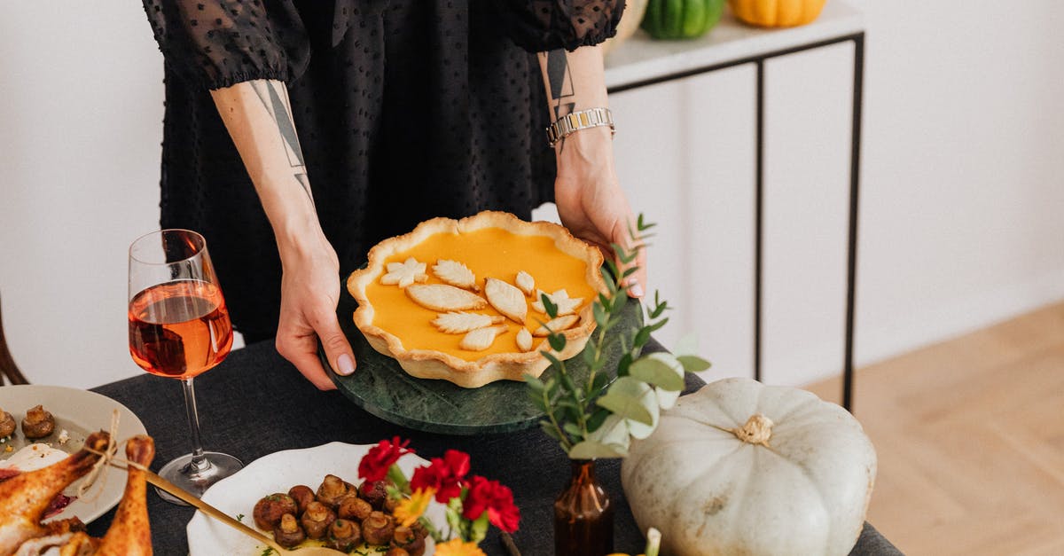 How to use pie weights? - Woman in Black Dress Holding a Yellow and Green Pumpkin