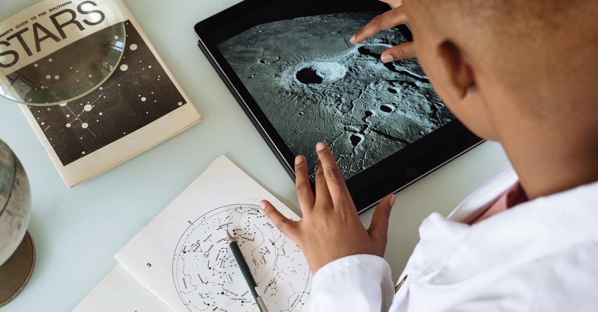 How to use stock from tablet - Crop African American student studying craters of moon on tablet at observatory