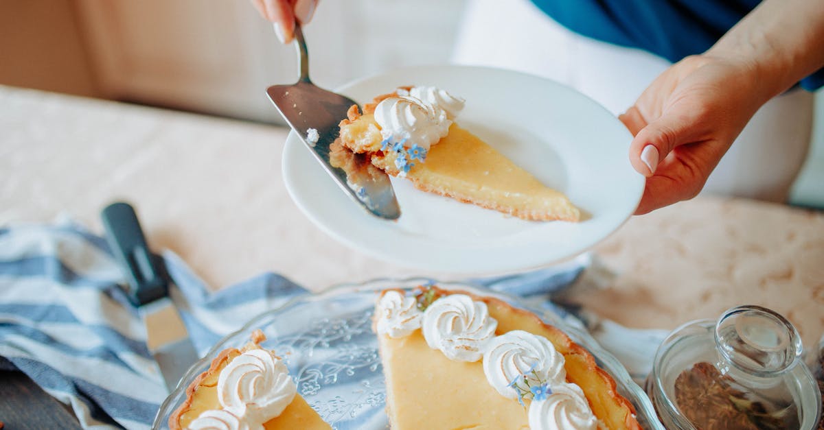 How to veganize and improve this cake recipe? - Anonymous woman with pie on plate near table in kitchen