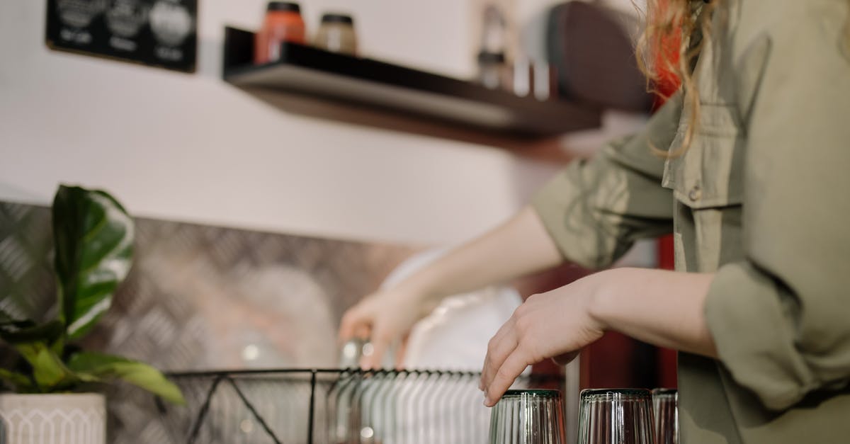 How to wash amaranth before cooking> - Woman in Gray Long Sleeve Shirt Holding Clear Glass Container