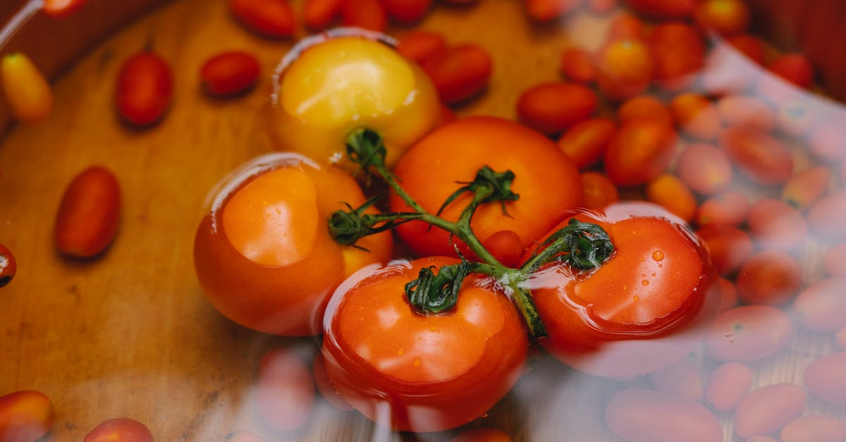 How to wash vegetables without running water? - Bunch of harvested red tomatoes in water bowl