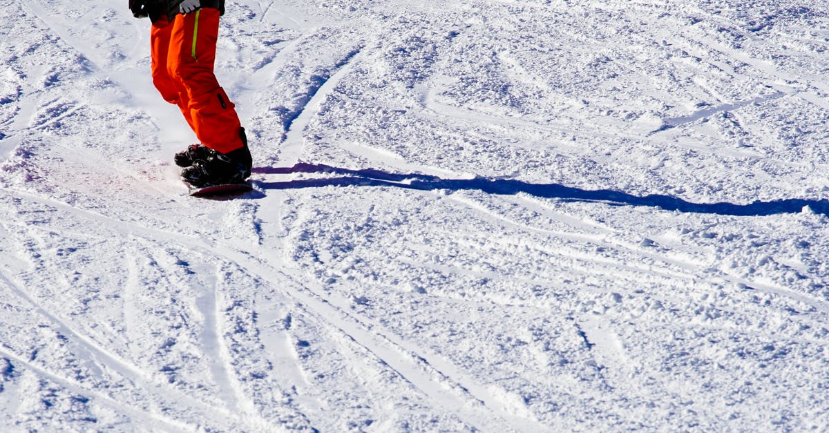 How well do frozen oranges peel after frozen? - Photo of Person Wearing Black Top and Orange Pants Riding Snowboard