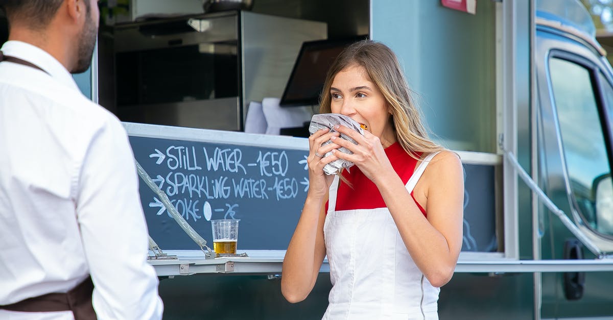 How would I go about recreating beef/hamburger taste/umami, strictly vegan? - Calm woman in stylish clothes standing near food truck and eating tasty burger on street in daytime