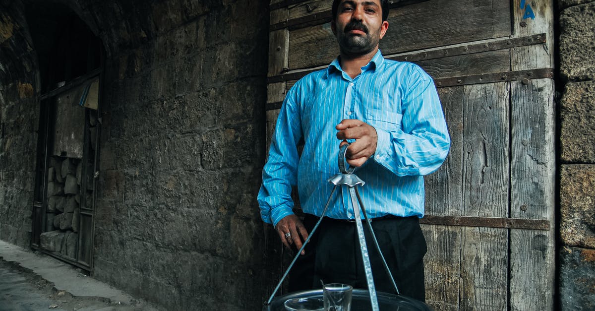 I have an old pyrex bowl with a detachable handle with a glass inset - Stylish bearded ethnic man with tray in old house I have an old pyrex bowl with a detachable handle with a glass inset - Stylish bearded ethnic man with tray in old house