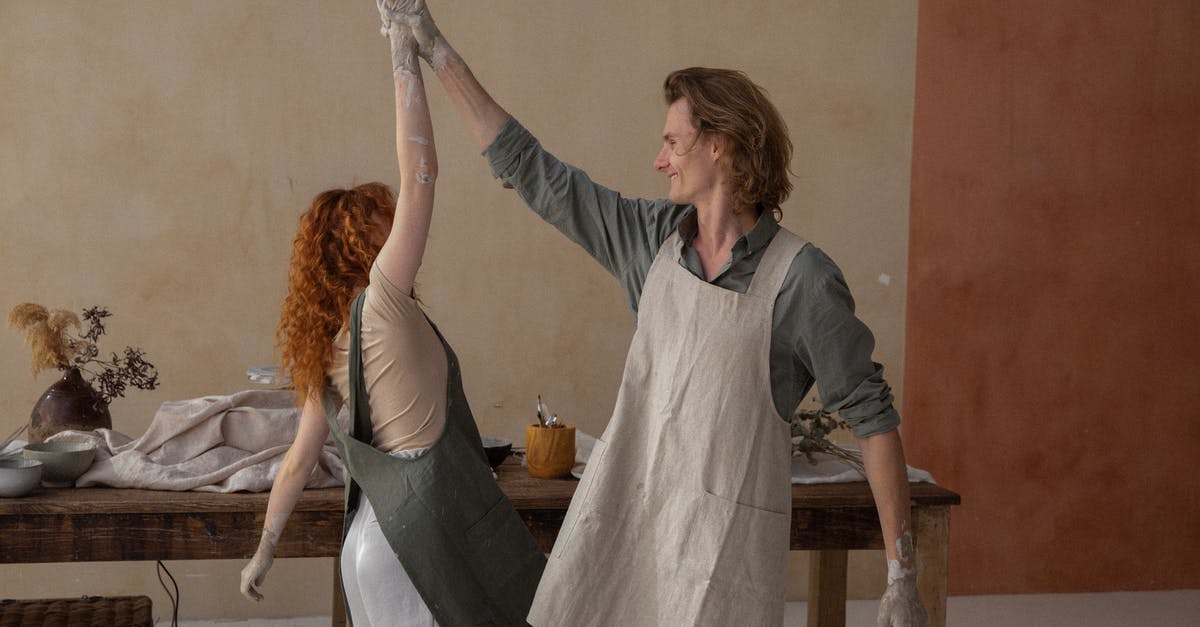 I love "Mastering the Art of French Cooking". Can someone recommend similar books for other cuisines? [closed] - Happy couple with dirty hands in clay dancing and smiling after working in creative studio