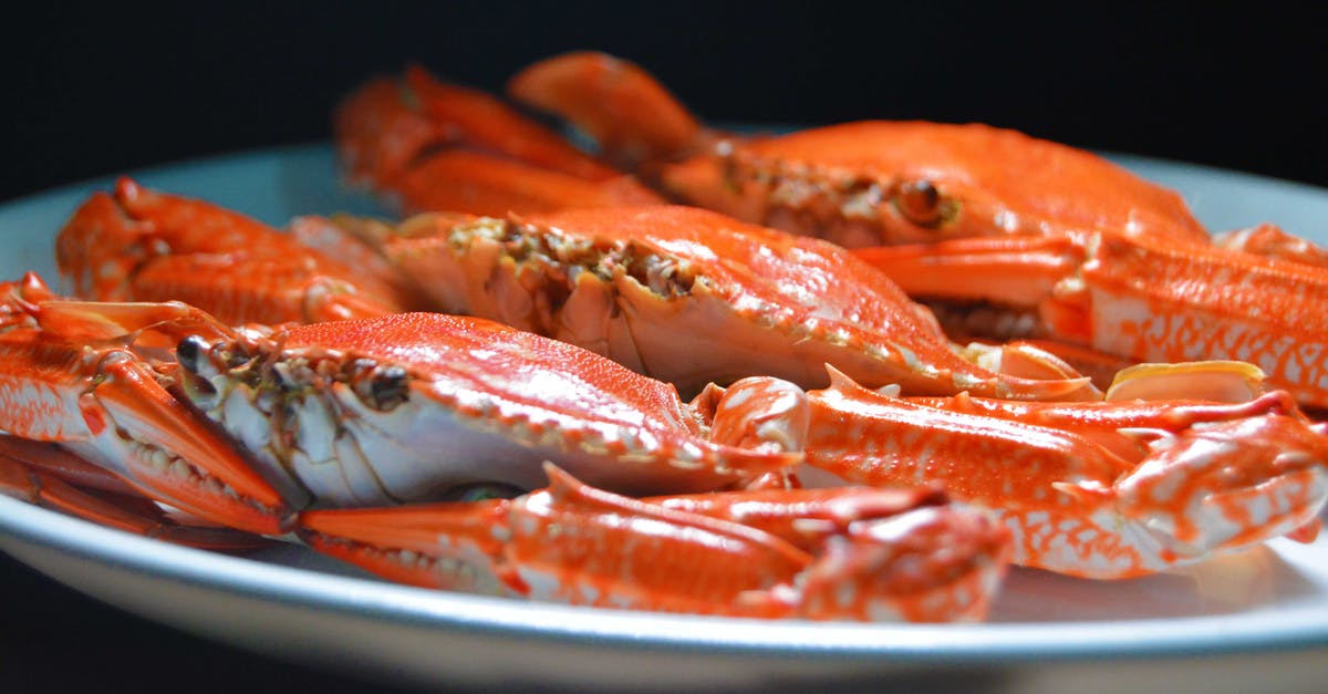 Identify this seafood from the Black Sea known in Romanian as "rapane"? - Photo of a Crab on a White Ceramic Plate
