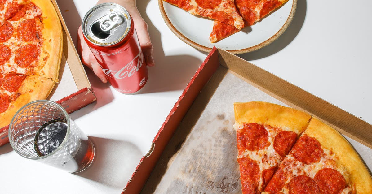 Identifying a type of Pizza Topping - Person Holding Coca-Cola In Can Beside Pizza on Table
