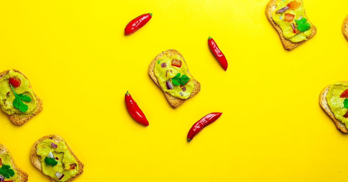 Identifying a white crispy garnish to a pork dish - Tasty Mexican guacamole on slice of bread