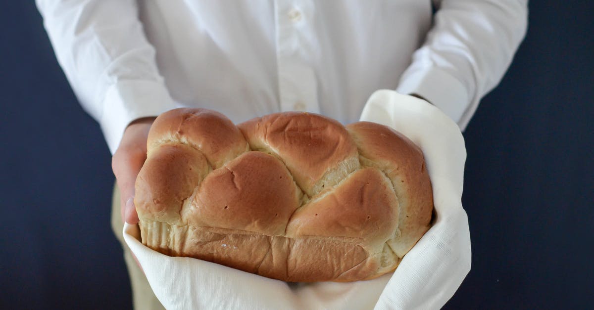 In reference to baking bread, what is a "mother culture"? - Brown Bread Held by a Person