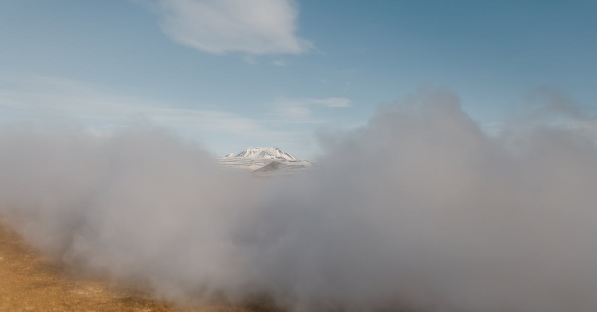 Induction range vs gas - Scenery of dense gray clouds covering spacious mountainous valley against clear blue sky