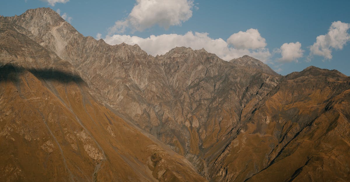 intermittent solid crust on top of yogurt - Mountain range with steep ridges in highland