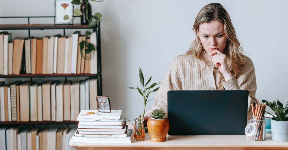 Internal temperature of cuts containing abundance of connective tissue - Serious female surfing internet on netbook while sitting at table near wall in light room with collection of books on shelves