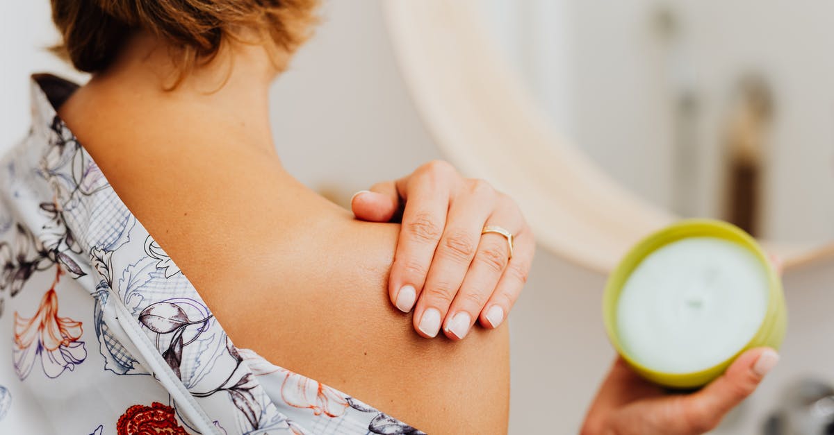 Irish Cream Manufacturing - Woman Putting Cream on Shoulder