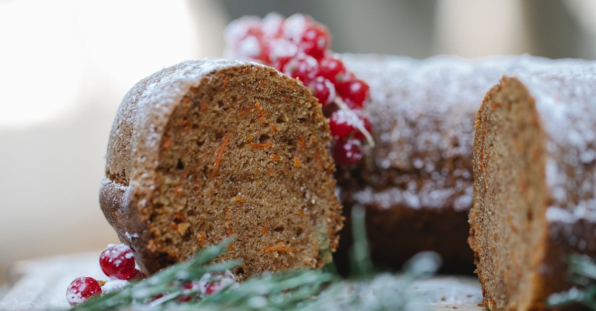 Is a sprouting carrot lower in sugar and does it lose nutritional value? - Appetizing homemade chocolate sponge cake with berries and rosemary sprig placed on table against blurred background
