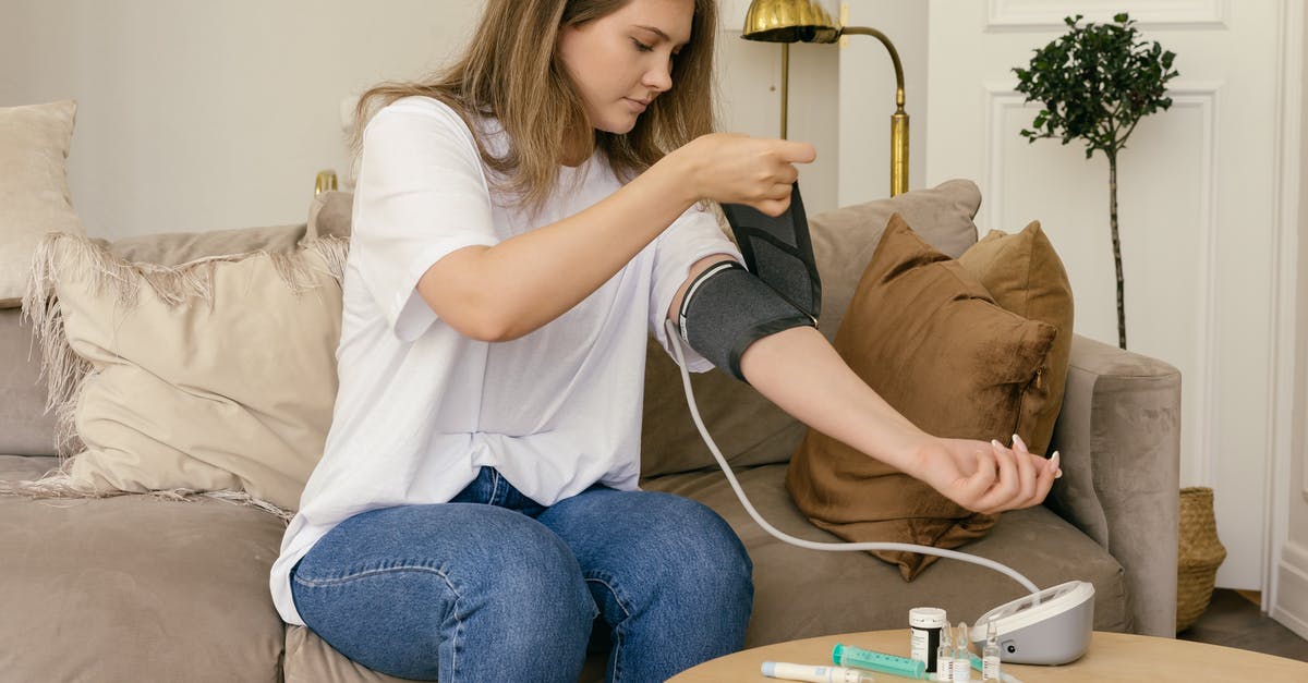 Is bacon fat supposed to congeal at room temperature? - Woman in White T-shirt and Blue Denim Jeans Sitting on Brown Sofa