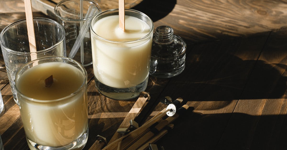 Is candle wax and cheese wax the same thing? - Glasses with organic candles on wooden table