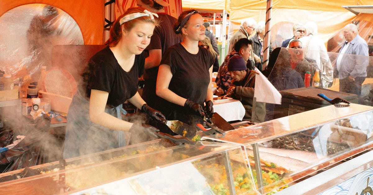 Is carnival glass safe for serving food? - Women in Black Shirt Selling Food in Food Stall
