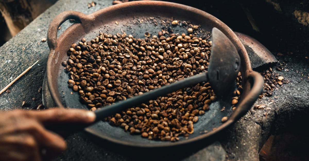 Is cooking beans or any other food in metal cans safe? - Coffee Beans on Round Wok