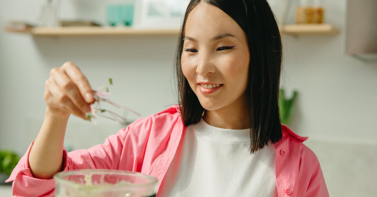 Is cooking with an air fryer similar, nutritionally, to baking? - Woman in Pink Long Sleeve Shirt Holding Clear Drinking Glass