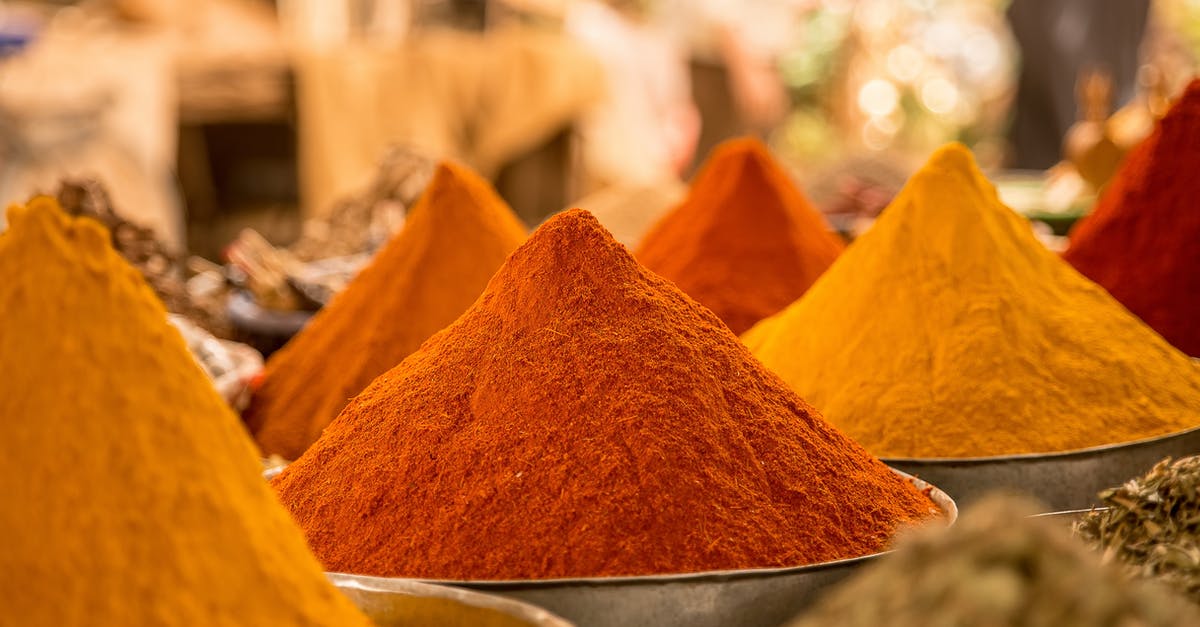 Is curry ketchup just ketchup with curry powder? - Close Up of Powdered Spices on Market Stall