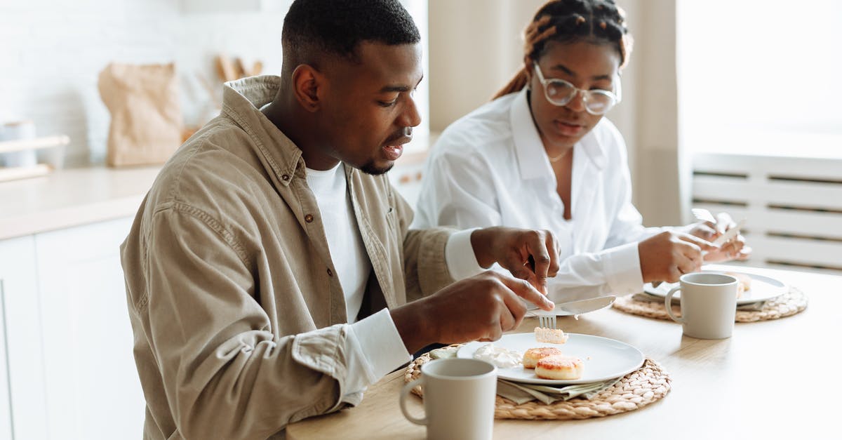 Is eating soap or bleach dangerous? - Man in White Dress Shirt Sitting Beside Man in White Dress Shirt Eating