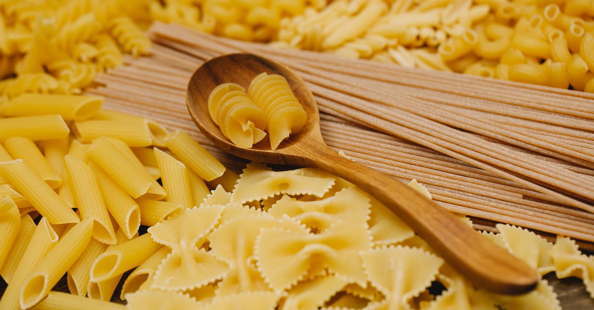 Is eating uncooked spaghetti dangerous? - Different types of raw pasta with wooden spoon