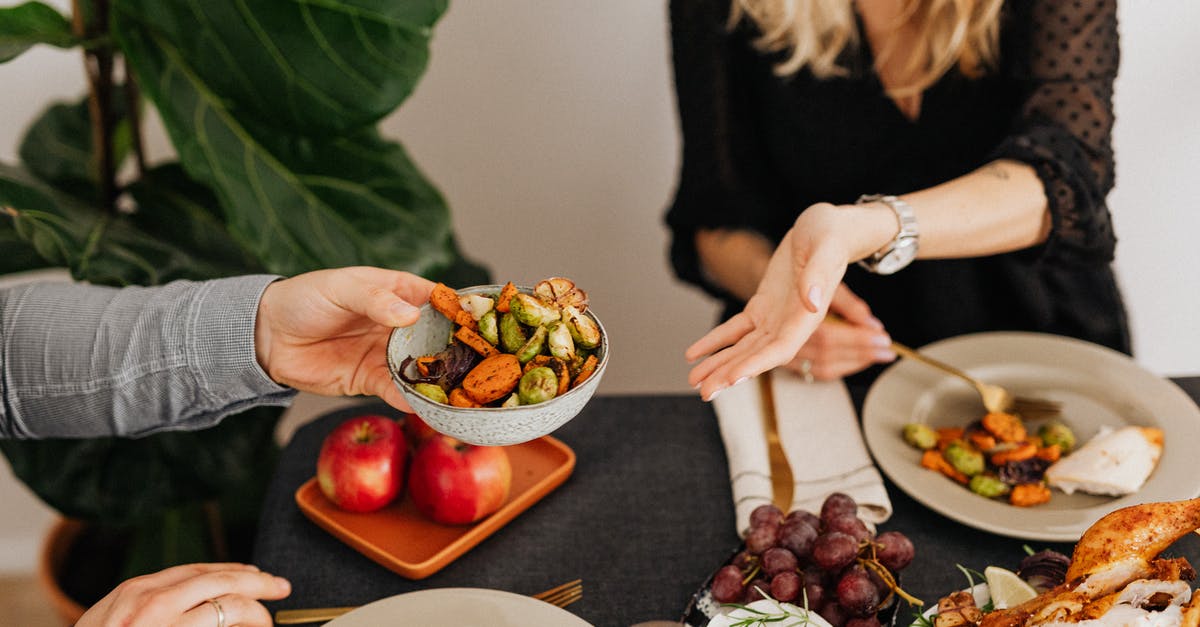 Is free-range chicken more flavourful? - Woman in Black Long Sleeve Shirt Holding Brown and Red Round Fruit